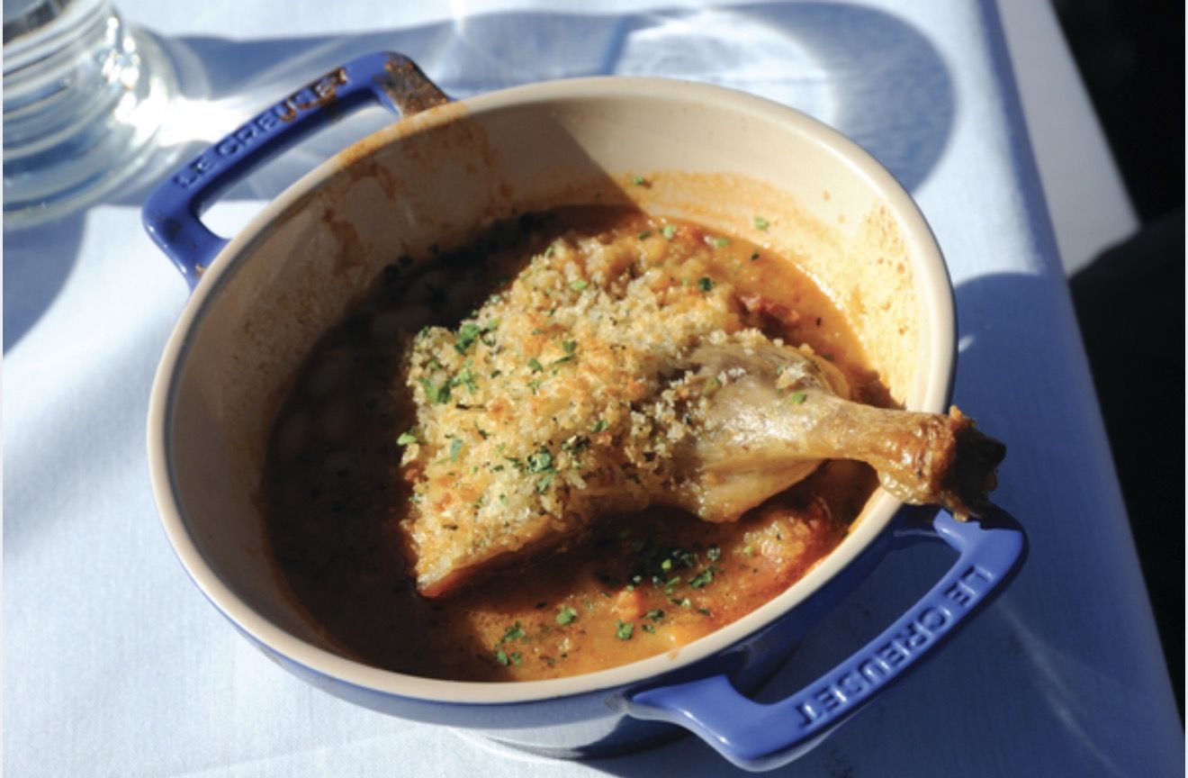 Duck cassoulet served in a cast-iron pot on the deck at Bon Vivant