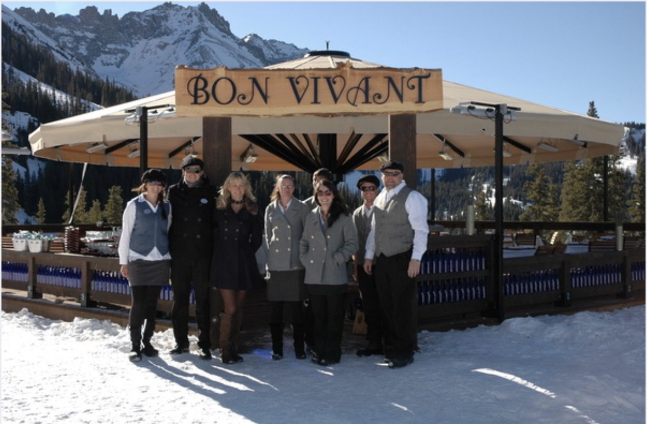 The Bon Vivant team gathered beneath the carved sign and heated umbrella at the top of Lift 5